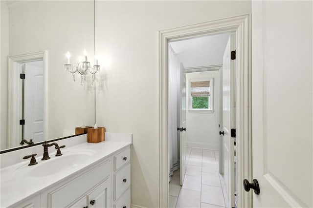 bathroom featuring baseboards, tile patterned flooring, and vanity