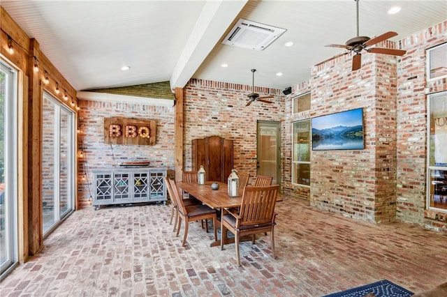 dining room featuring brick floor, brick wall, vaulted ceiling with beams, and ceiling fan