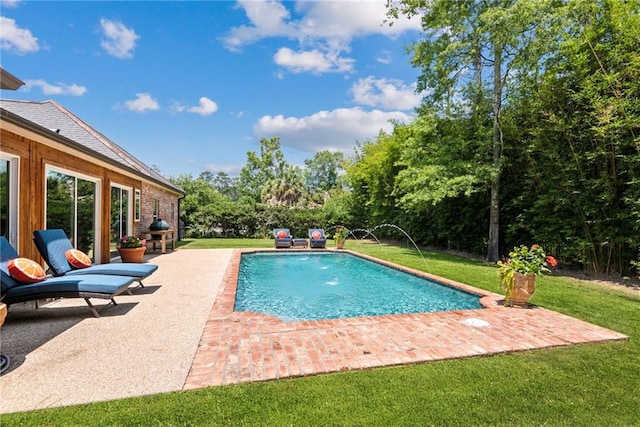 pool featuring a yard and a patio