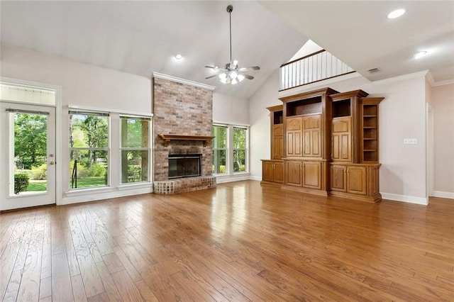 unfurnished living room with a ceiling fan, baseboards, light wood-style flooring, a brick fireplace, and high vaulted ceiling