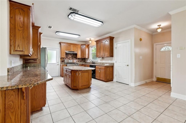 kitchen featuring stainless steel appliances, visible vents, ornamental molding, brown cabinetry, and light tile patterned floors