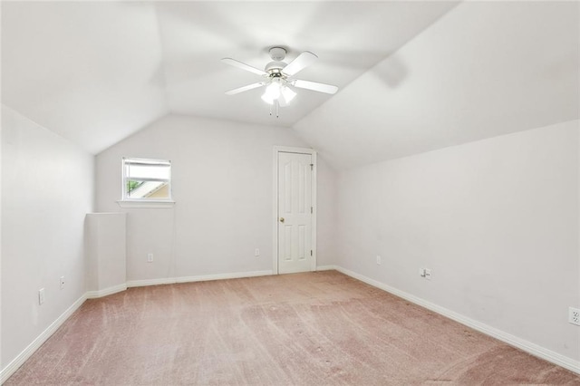 additional living space with baseboards, light carpet, a ceiling fan, and lofted ceiling