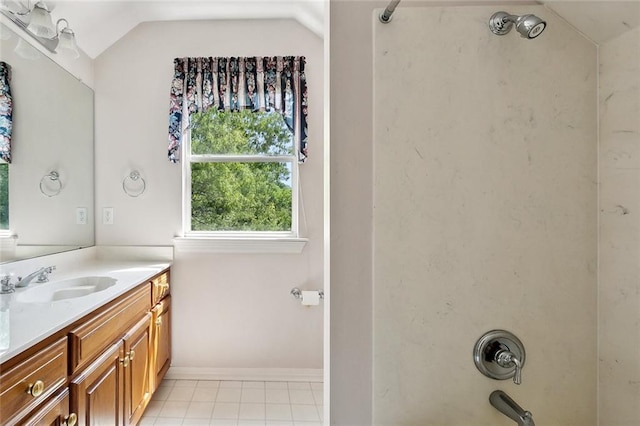 full bath with baseboards, lofted ceiling, shower / washtub combination, tile patterned flooring, and vanity