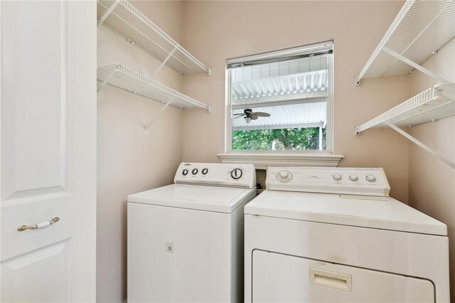 washroom with separate washer and dryer, a ceiling fan, and laundry area