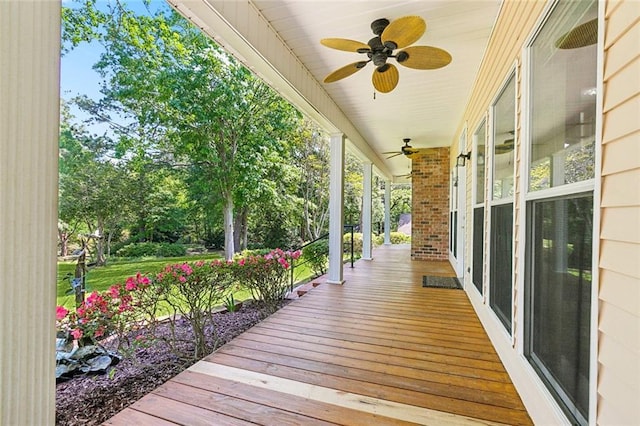 wooden deck featuring a ceiling fan and a porch