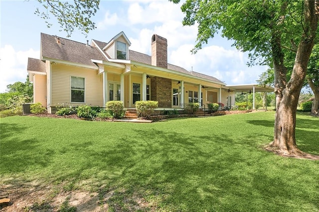 rear view of house featuring a yard, central air condition unit, a chimney, and ceiling fan