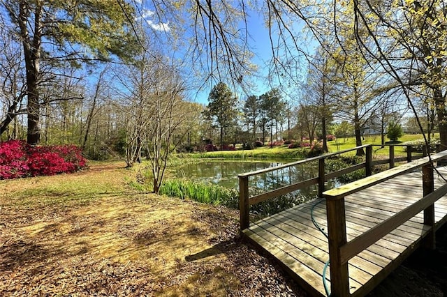 wooden terrace featuring a water view