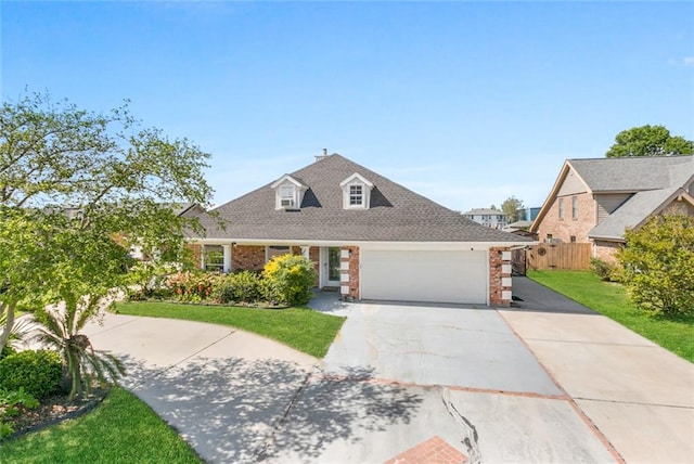 view of front of property with fence, driveway, brick siding, a front yard, and a garage