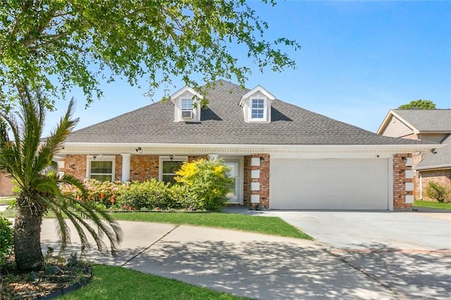 view of front of home with concrete driveway, brick siding, roof with shingles, and a garage