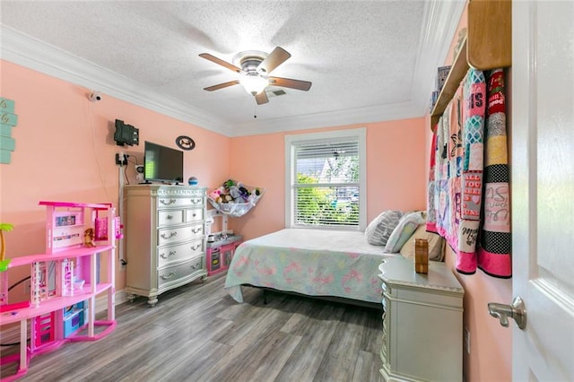 bedroom with a ceiling fan, crown molding, wood finished floors, a textured ceiling, and visible vents