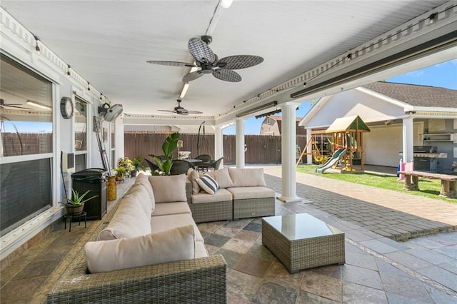 view of patio with an outdoor hangout area, a playground, fence, and ceiling fan
