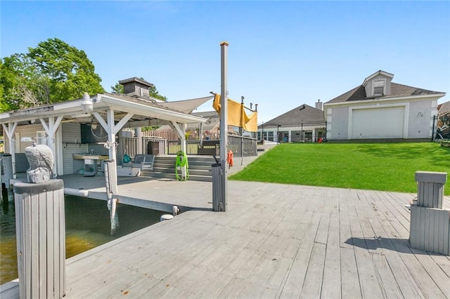 dock area with a lawn, a wooden deck, and a gazebo