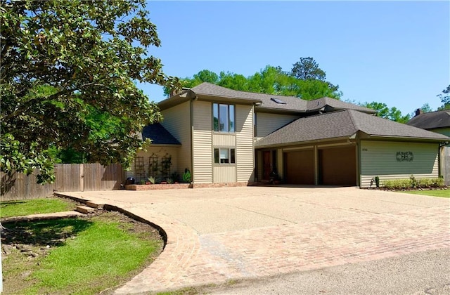 31765 River Pines Dr, Springfield, LA 70462 - view of front of house with an attached garage, fence, roof with shingles, and decorative driveway