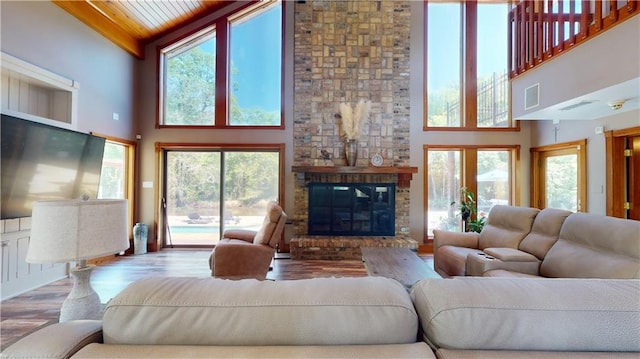31765 River Pines Dr, Springfield, LA 70462 - living room with a fireplace, wood finished floors, high vaulted ceiling, and plenty of natural light
