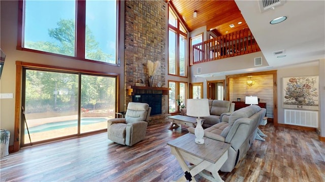 31765 River Pines Dr, Springfield, LA 70462 - living room featuring wood finished floors, a high ceiling, and visible vents