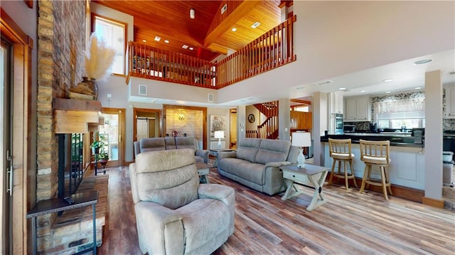 31765 River Pines Dr, Springfield, LA 70462 - living area with a high ceiling, wood finished floors, stairs, and visible vents