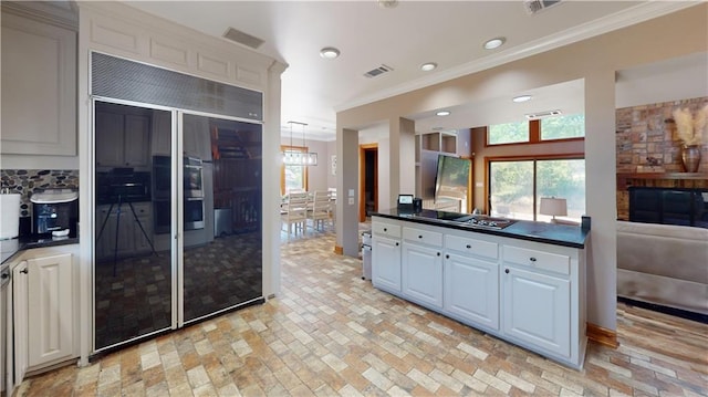 31765 River Pines Dr, Springfield, LA 70462 - kitchen featuring built in fridge, brick floor, and crown molding