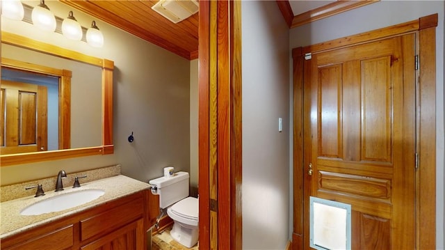 31765 River Pines Dr, Springfield, LA 70462 - bathroom with toilet, vanity, and crown molding