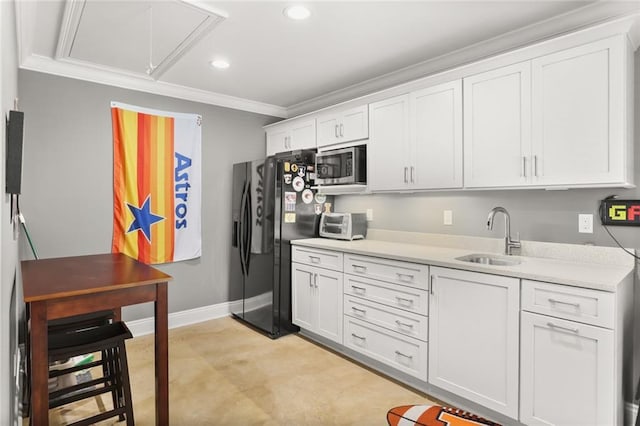 kitchen with recessed lighting, light countertops, a sink, stainless steel microwave, and crown molding
