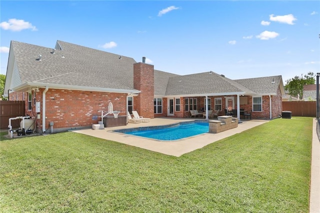 view of swimming pool with a fenced backyard, a yard, and a patio