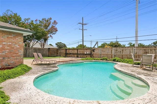 view of swimming pool with a fenced backyard, a fenced in pool, and a patio area