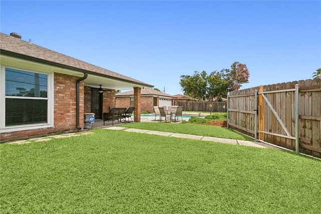 view of yard with a fenced in pool, a patio, ceiling fan, and a fenced backyard