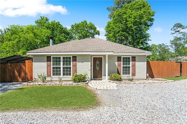 view of front of house with fence and a shingled roof