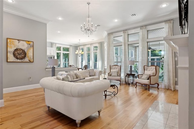 living room with recessed lighting, light wood finished floors, an inviting chandelier, ornamental molding, and baseboards