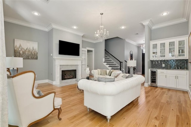 living area featuring stairway, bar, wine cooler, and light wood-style flooring