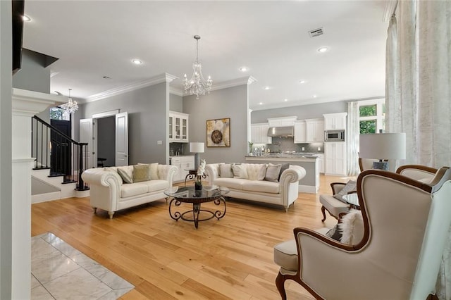 living area with stairs, visible vents, a chandelier, and ornamental molding