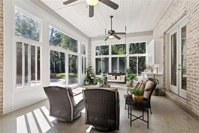sunroom with brick wall and ceiling fan