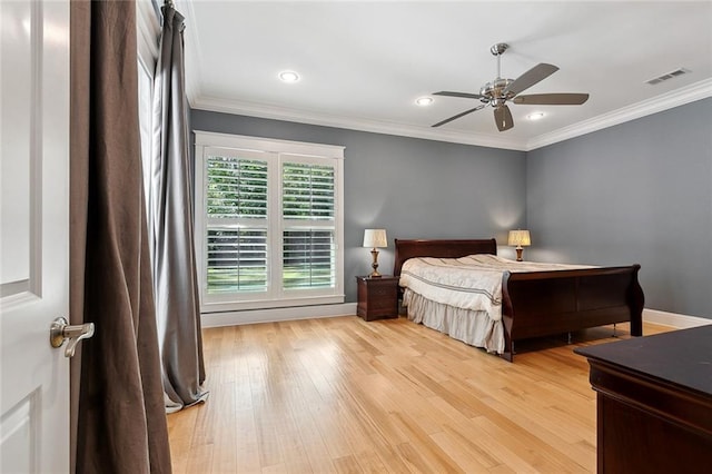 bedroom featuring light wood-style floors, baseboards, ornamental molding, visible vents, and recessed lighting