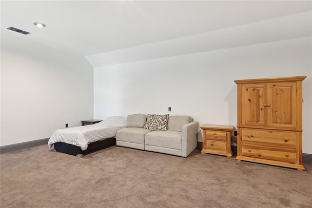 bedroom with vaulted ceiling, carpet floors, visible vents, and baseboards