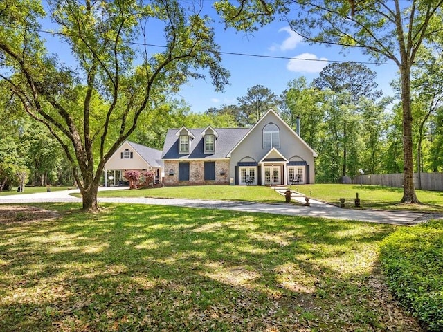 31035 Horseshoe Island Rd, Lacombe, LA 70445 - new england style home featuring french doors, a front yard, and fence
