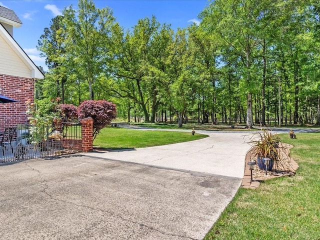 31035 Horseshoe Island Rd, Lacombe, LA 70445 - view of property's community with a yard, concrete driveway, and fence