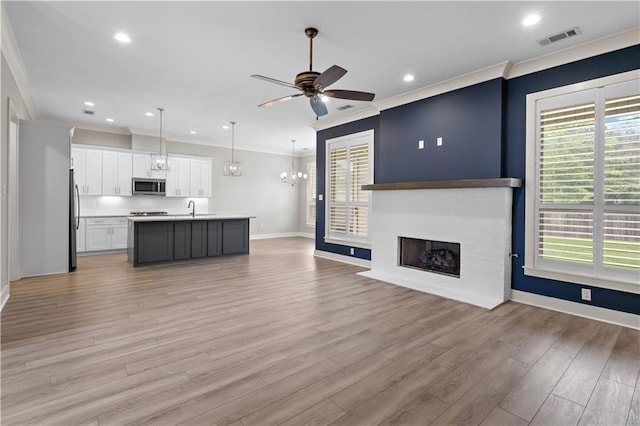 72421 Homestead St, Covington, LA 70435 - kitchen with visible vents, ornamental molding, open floor plan, and stainless steel appliances