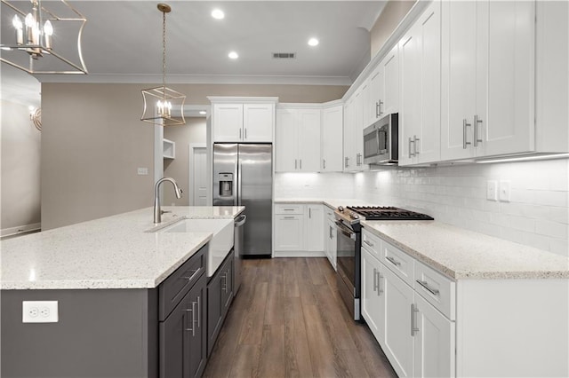 72421 Homestead St, Covington, LA 70435 - kitchen with a notable chandelier, stainless steel appliances, white cabinetry, and a sink