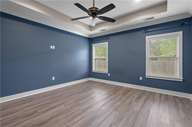 72421 Homestead St, Covington, LA 70435 - empty room with baseboards, visible vents, wood finished floors, ceiling fan, and a raised ceiling