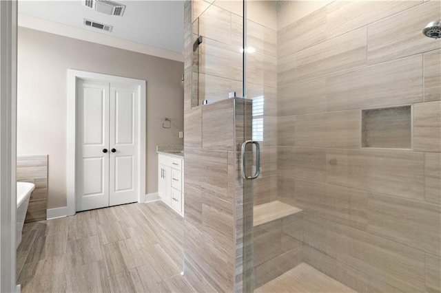 72421 Homestead St, Covington, LA 70435 - bathroom with baseboards, a soaking tub, visible vents, and a stall shower