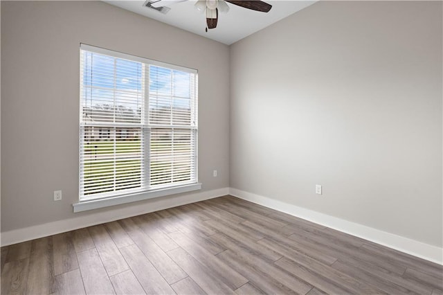 72421 Homestead St, Covington, LA 70435 - unfurnished room with baseboards, wood finished floors, visible vents, and ceiling fan