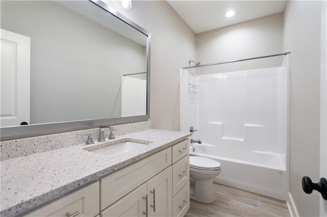 72421 Homestead St, Covington, LA 70435 - full bathroom with toilet, vanity, wood finished floors, and  shower combination