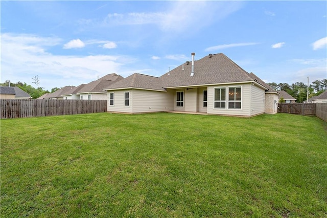 72421 Homestead St, Covington, LA 70435 - rear view of house with a fenced backyard, roof with shingles, and a yard
