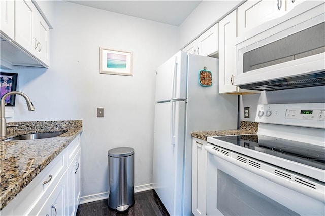 kitchen featuring light stone counters, a sink, white appliances, white cabinetry, and dark wood-style floors