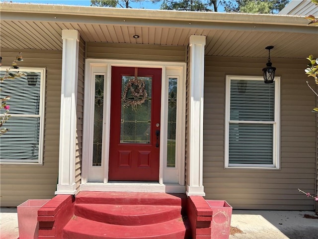view of exterior entry with covered porch
