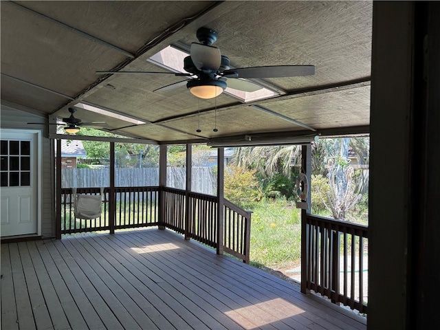 deck with ceiling fan and fence