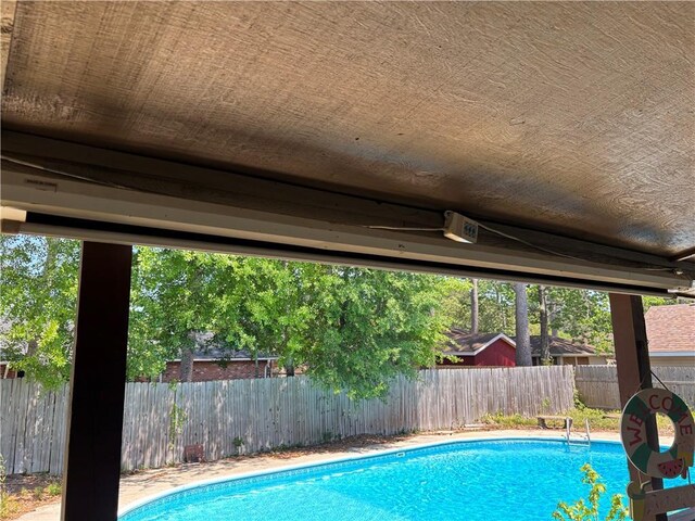 view of swimming pool featuring a fenced backyard and a fenced in pool