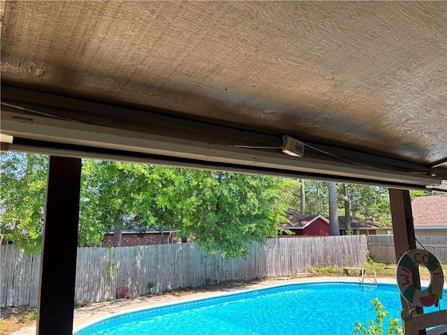 view of swimming pool with a fenced backyard and a fenced in pool