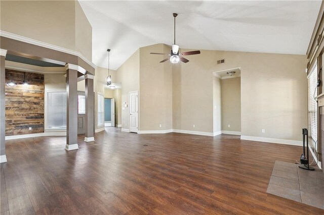 unfurnished living room with a fireplace with raised hearth, ceiling fan, baseboards, dark wood-type flooring, and visible vents