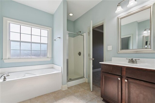 bathroom with a bath, a shower stall, tile patterned floors, and vanity