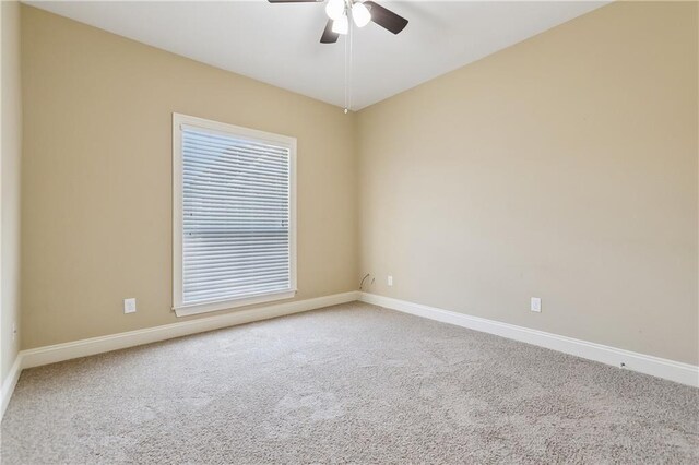 unfurnished room featuring baseboards, a ceiling fan, and carpet floors